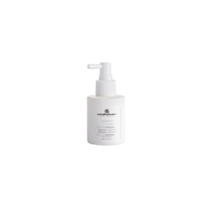 White pump-bottle of ExoHair Lotion on a plain white background, label facing forward